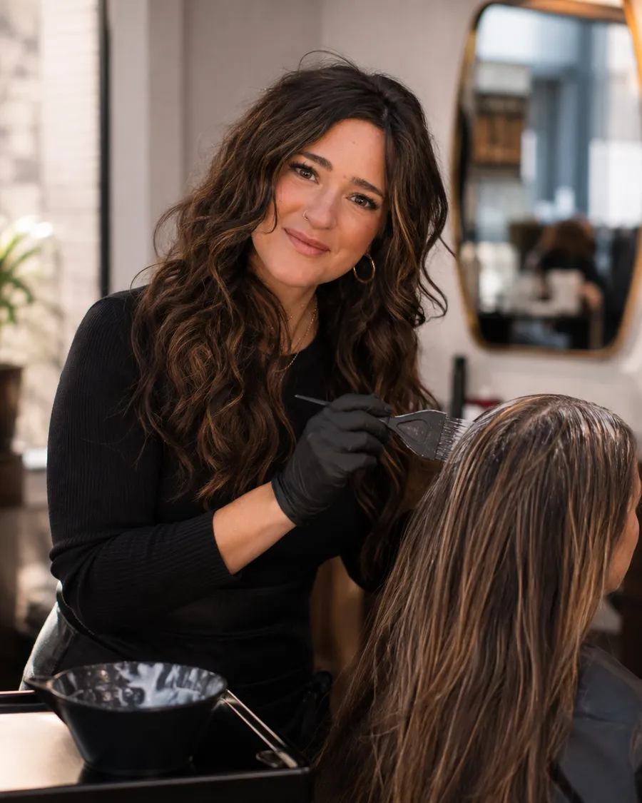 Brooke applying custom hair color to a client